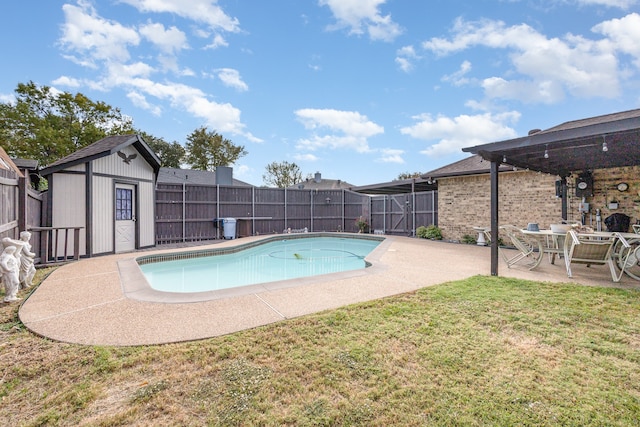 view of swimming pool with a storage unit, a patio area, and a lawn