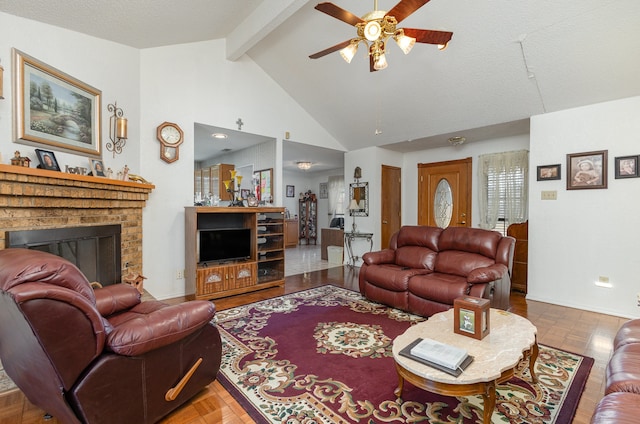 living room featuring a fireplace, a textured ceiling, ceiling fan, beam ceiling, and high vaulted ceiling