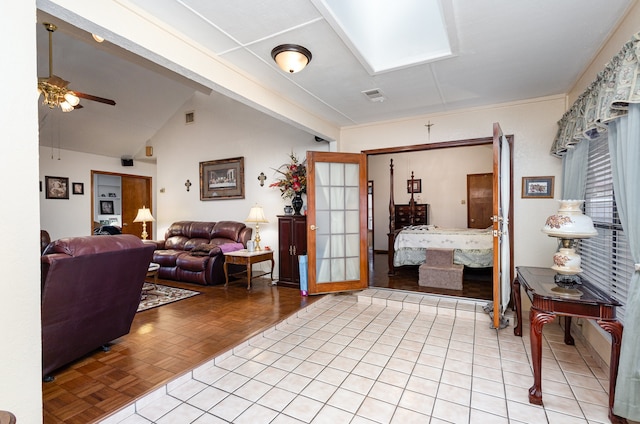 interior space with lofted ceiling with skylight and light parquet floors