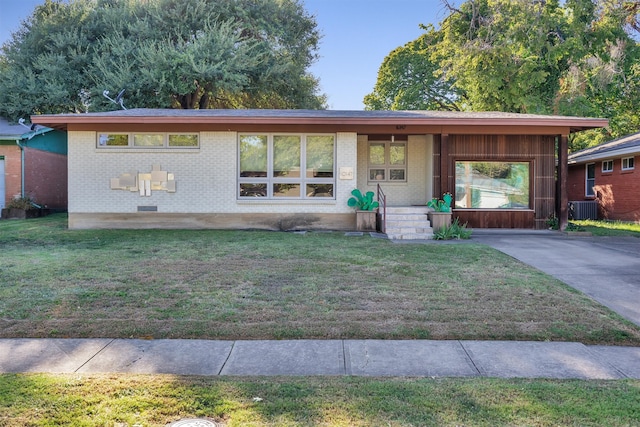 view of front facade with cooling unit and a front lawn