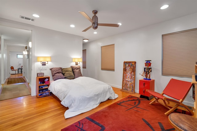 bedroom with hardwood / wood-style floors and ceiling fan