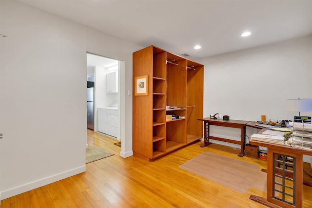 office featuring hardwood / wood-style flooring and washer / clothes dryer