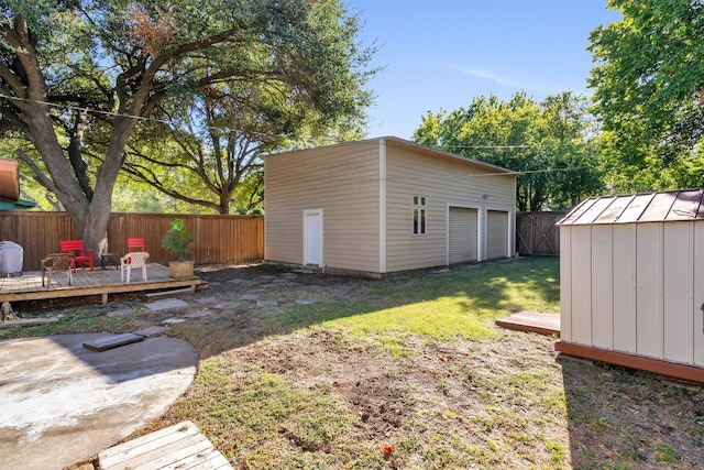 view of yard with a wooden deck and a storage unit