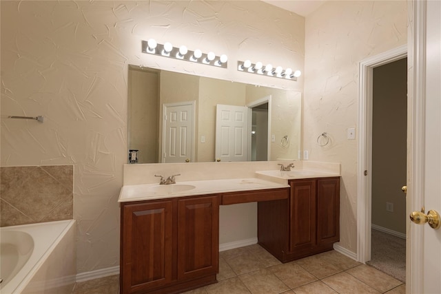 bathroom featuring vanity, tile patterned floors, and a bath