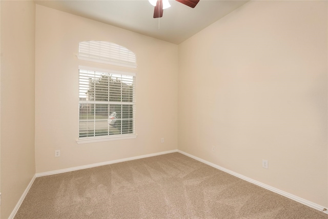 carpeted spare room with ceiling fan and lofted ceiling