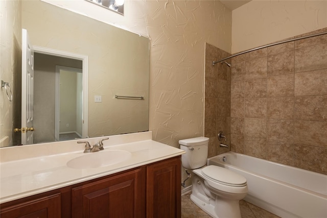 full bathroom featuring tiled shower / bath, vanity, toilet, and tile patterned floors