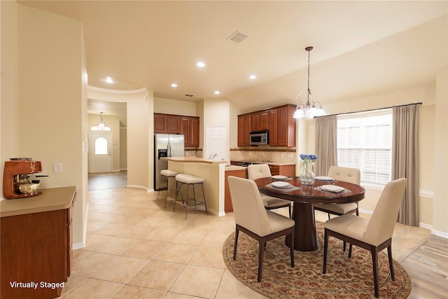 dining space featuring a notable chandelier and light tile patterned floors