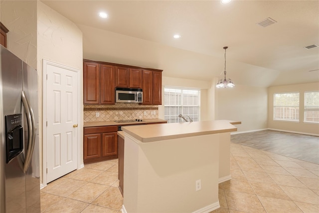 kitchen featuring a wealth of natural light, stainless steel appliances, light tile patterned floors, and a center island with sink