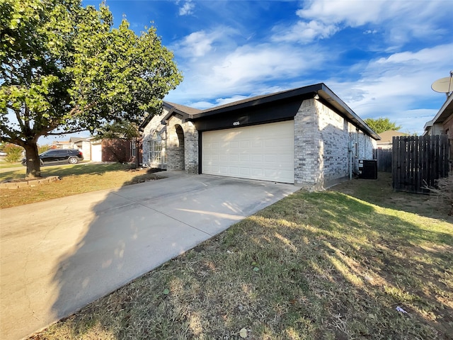 view of home's exterior with central AC, a garage, and a lawn