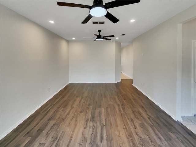 unfurnished room featuring ceiling fan and dark hardwood / wood-style flooring