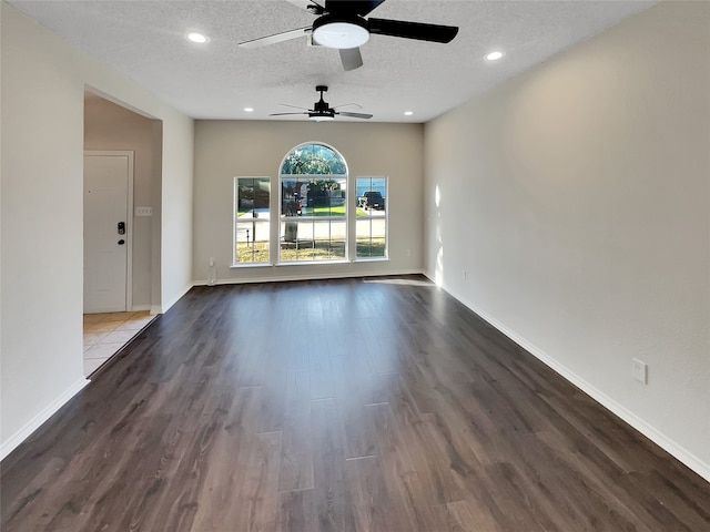 interior space with a textured ceiling, hardwood / wood-style flooring, and ceiling fan