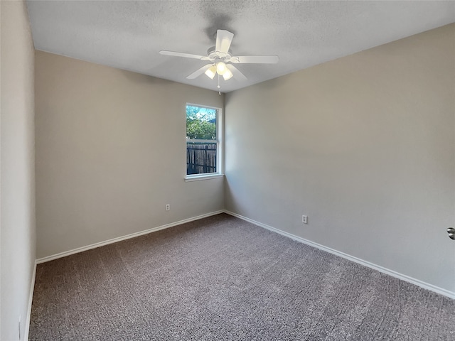 empty room featuring a textured ceiling, carpet, and ceiling fan