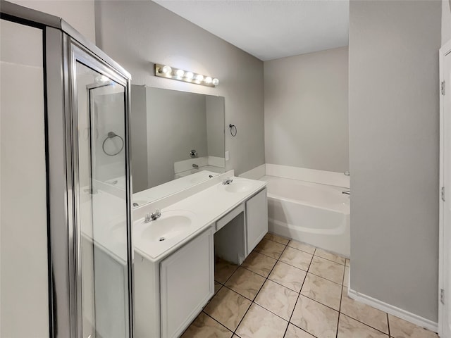 bathroom with a bathtub, tile patterned flooring, and vanity