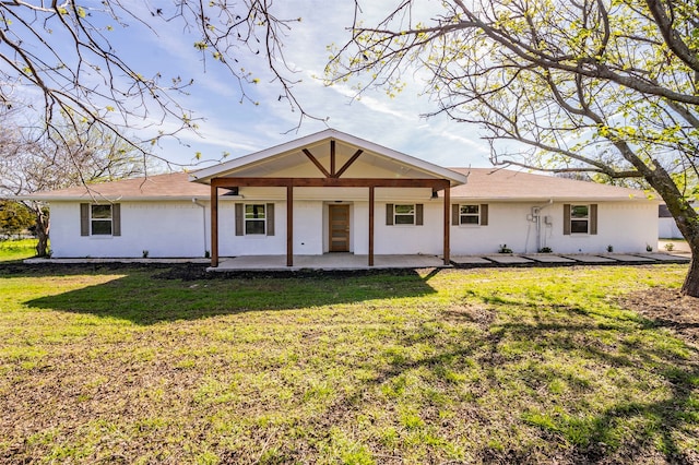 view of front facade with a front lawn and a patio area