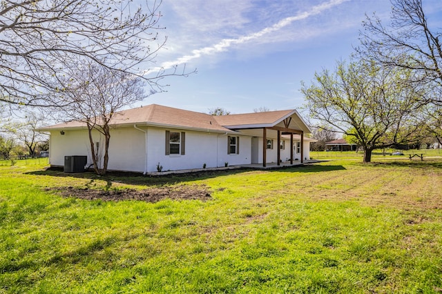 rear view of property with a yard and cooling unit