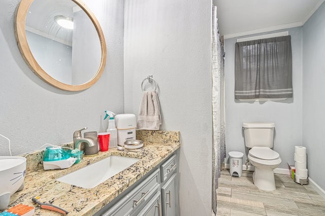 bathroom with vanity, curtained shower, ornamental molding, and toilet