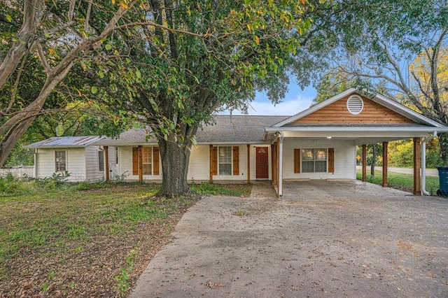 view of front of house with a front yard and a carport