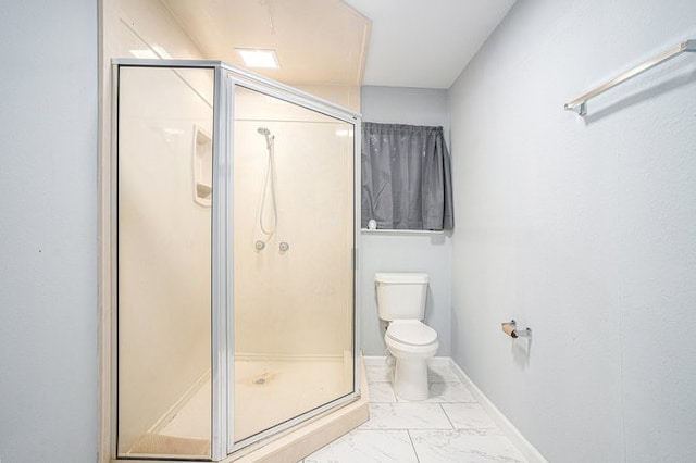 bathroom with a shower with door and toilet