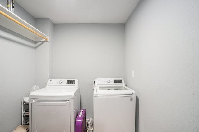 washroom with independent washer and dryer