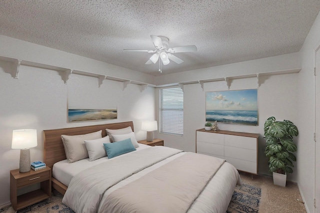 bedroom featuring carpet floors, a textured ceiling, and ceiling fan