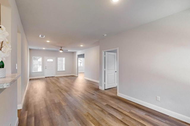 unfurnished living room with light hardwood / wood-style floors and ceiling fan