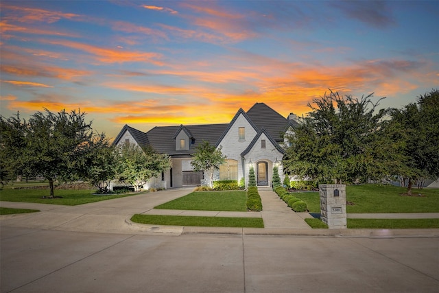 french country home with a lawn