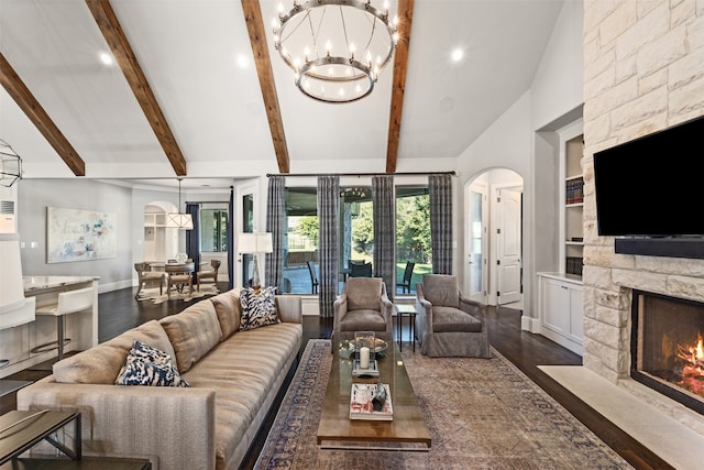 living room with beam ceiling, a fireplace, an inviting chandelier, and dark hardwood / wood-style flooring