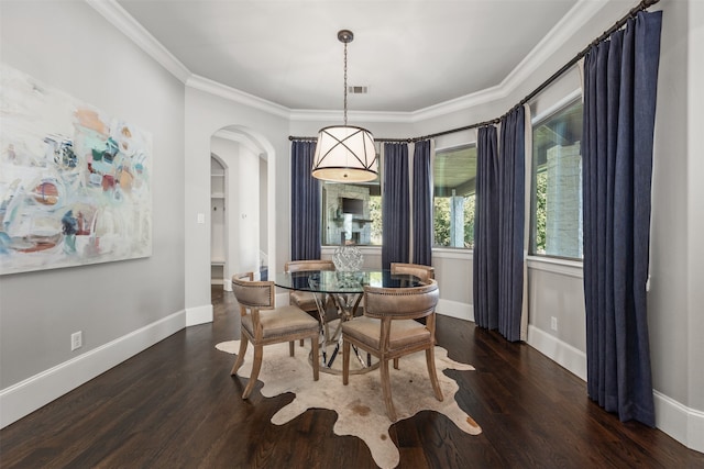 dining space featuring crown molding and dark hardwood / wood-style flooring