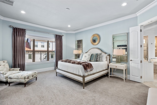 bedroom featuring ensuite bath, light carpet, and crown molding