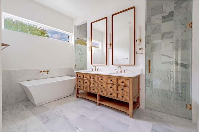 bathroom featuring vanity, tile walls, and separate shower and tub