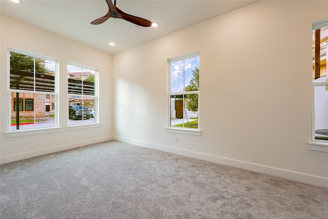 empty room with ceiling fan and carpet