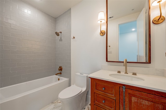 full bathroom with tiled shower / bath, vanity, and toilet