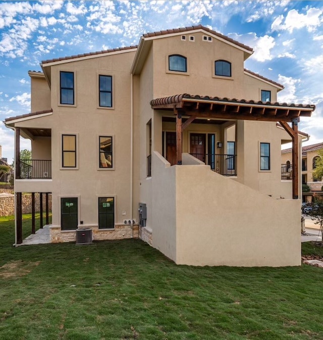 back of property featuring a lawn and a balcony