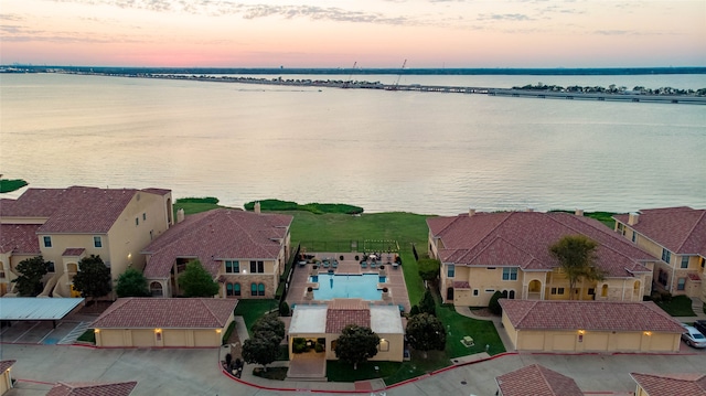 aerial view at dusk with a water view