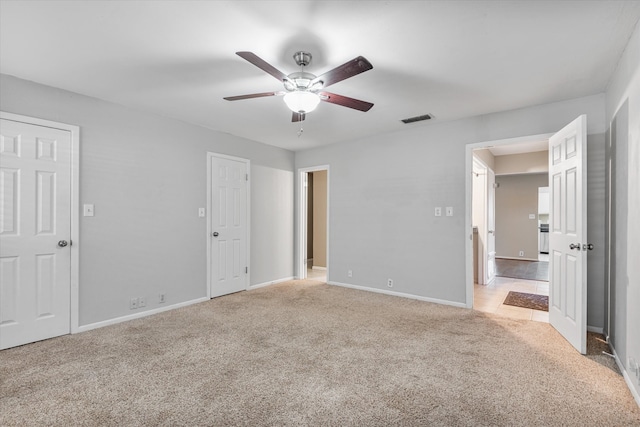 unfurnished bedroom with ceiling fan and light carpet