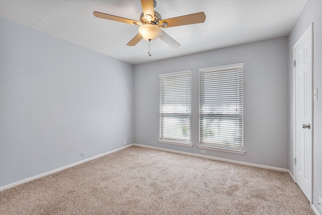 carpeted empty room featuring ceiling fan