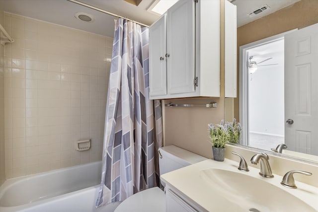 full bathroom with vanity, shower / bath combo with shower curtain, toilet, and ceiling fan