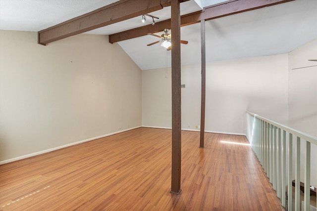 interior space with vaulted ceiling with beams, hardwood / wood-style flooring, and ceiling fan