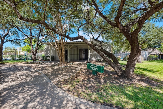 view of front of property featuring a front lawn and a carport