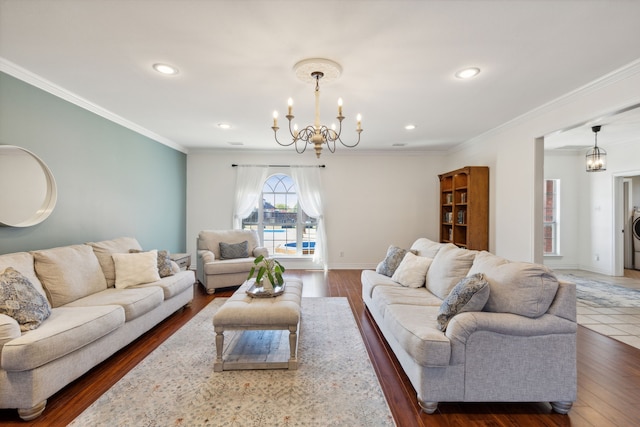 living room featuring a notable chandelier, ornamental molding, and dark wood-type flooring