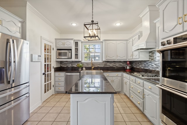 kitchen featuring sink, light tile patterned flooring, a kitchen island, stainless steel appliances, and custom range hood