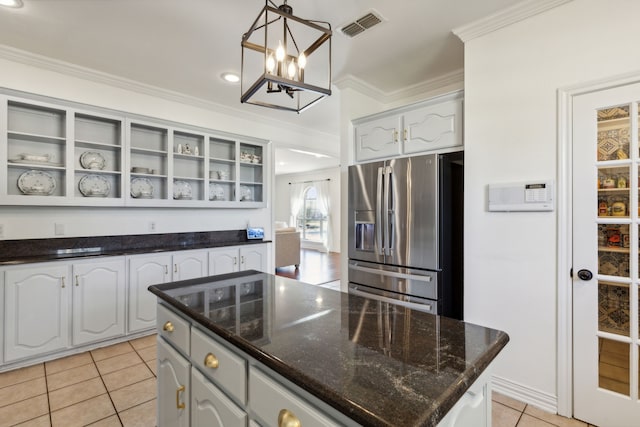 kitchen featuring white cabinetry, ornamental molding, pendant lighting, and stainless steel refrigerator with ice dispenser