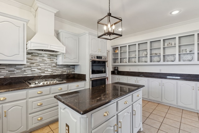 kitchen with stainless steel appliances, custom exhaust hood, and white cabinets