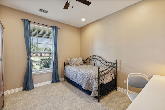 bedroom featuring light carpet and ceiling fan