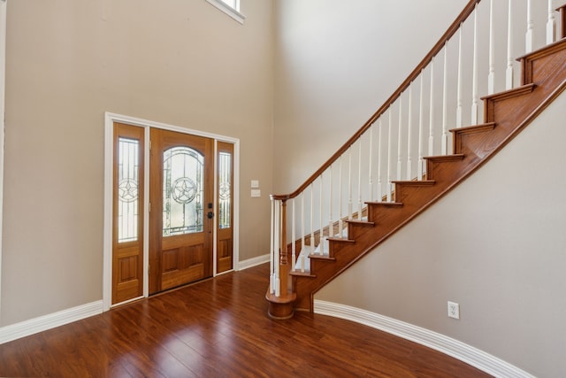 foyer featuring a high ceiling, hardwood / wood-style flooring, and plenty of natural light