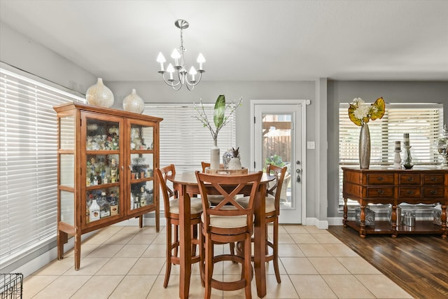 dining room with light hardwood / wood-style floors and an inviting chandelier