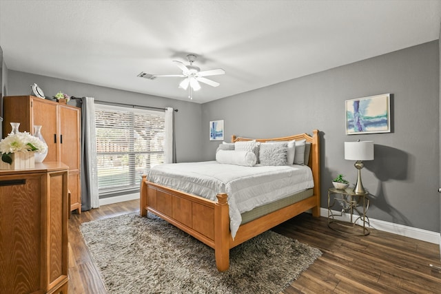 bedroom with ceiling fan and dark hardwood / wood-style flooring