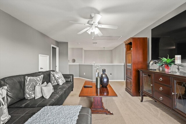 carpeted living room with ceiling fan