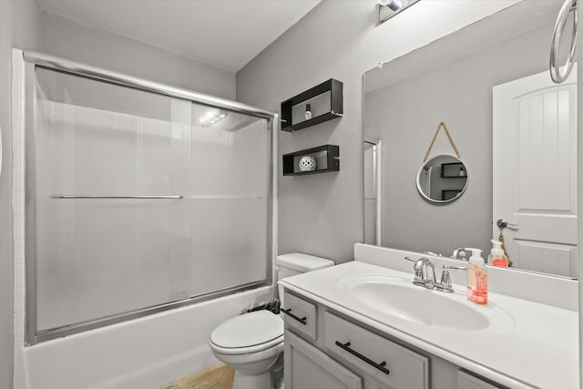 full bathroom featuring shower / bath combination with glass door, vanity, and toilet