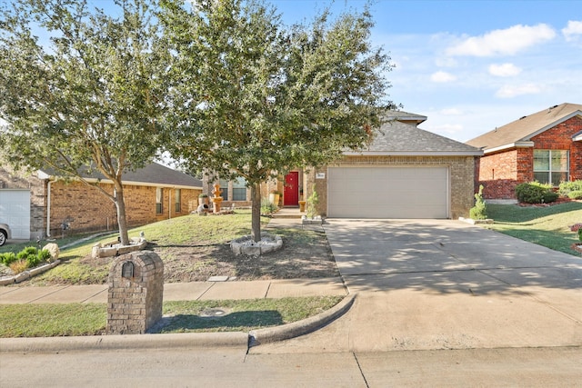 view of front of house featuring a garage and a front lawn